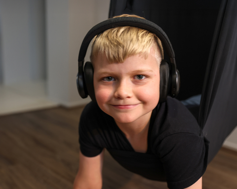 young boy wearing earphones on his ears
